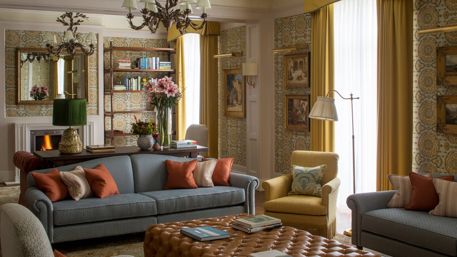 Royal Suite vintage wallpaper, gold-framed paintings, flowers around seating area