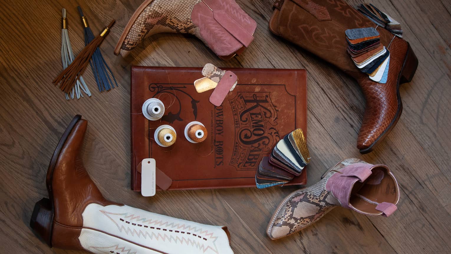 A book surrounded by cowboy boots and tassels