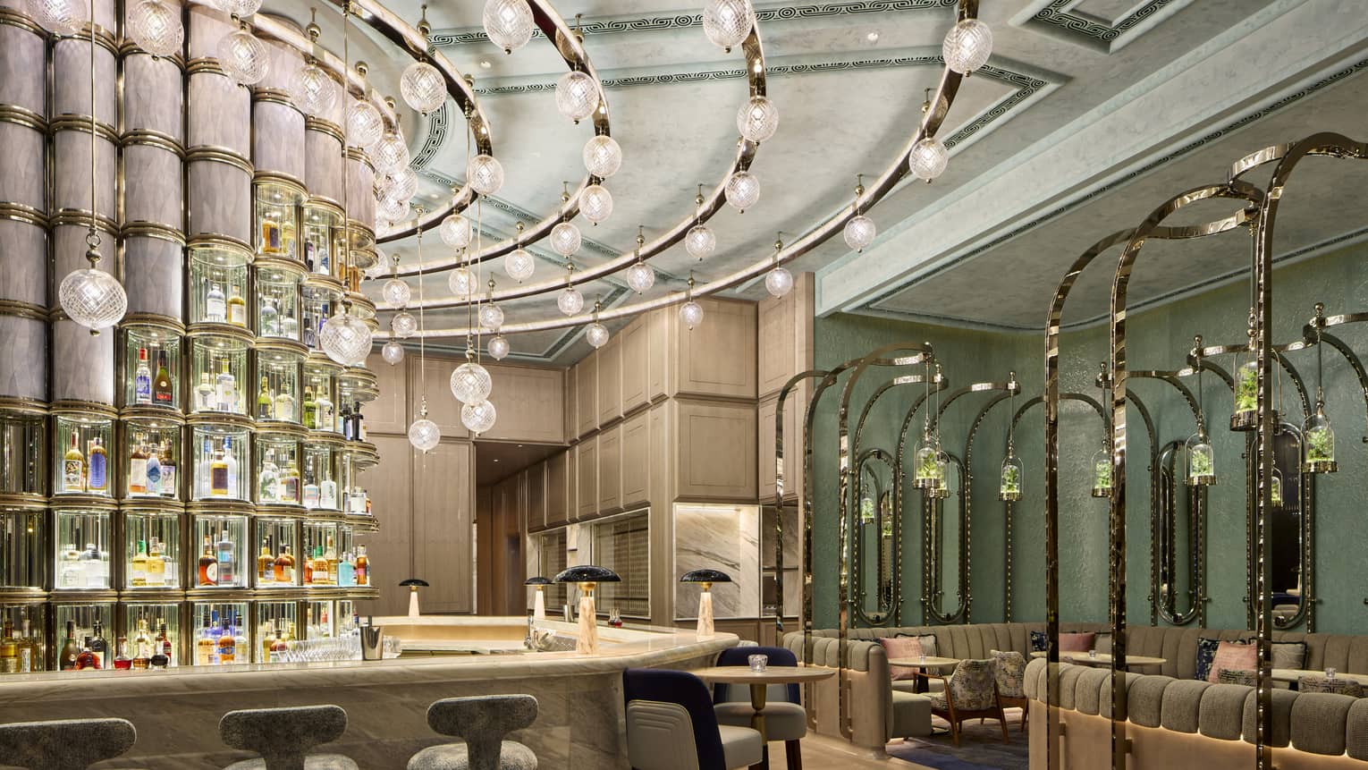 Curved bar with curved track lighting, curved wall of liquor bottles behind bar