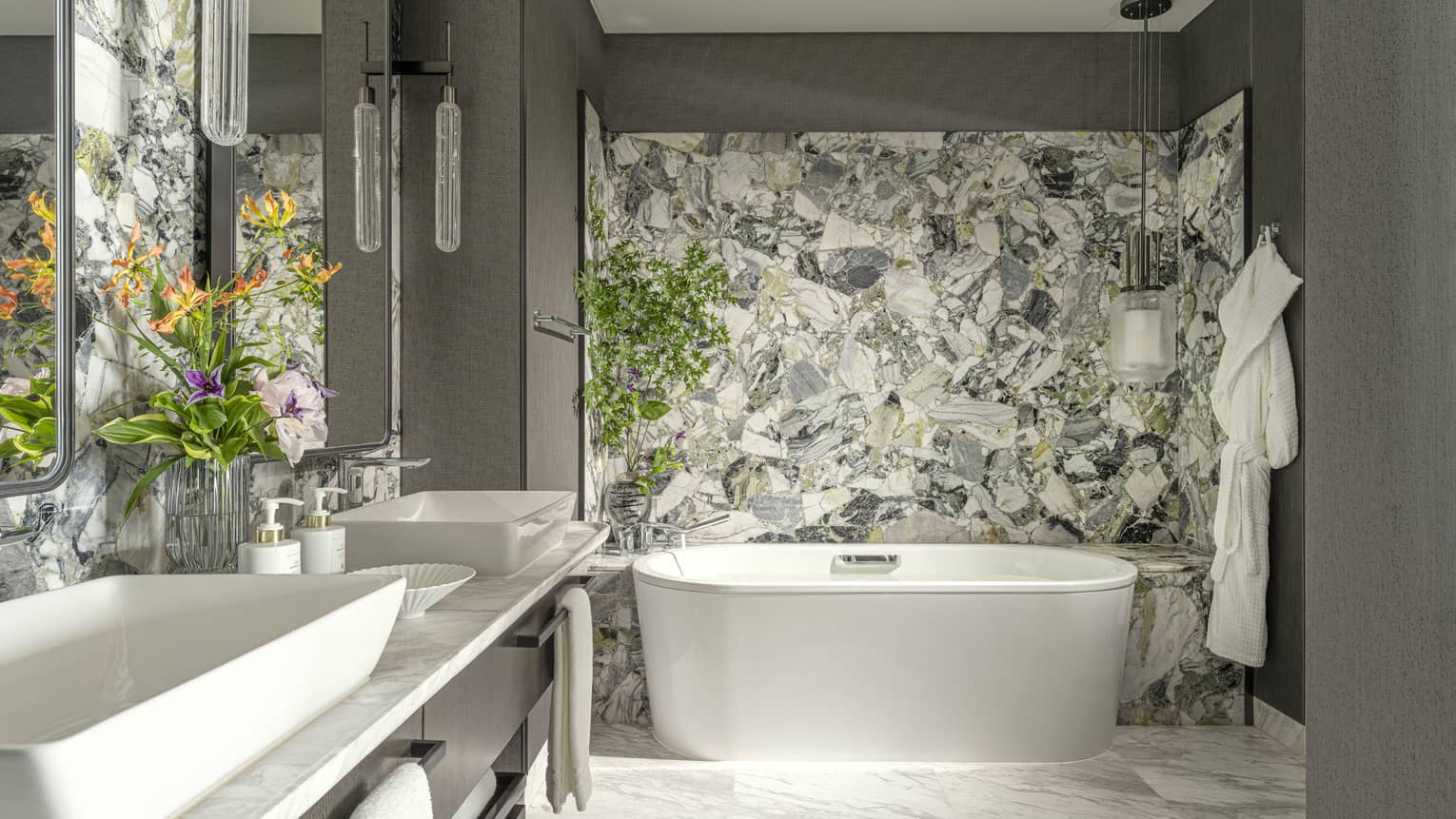 Modern hotel suite bathroom with standalone tub and double vanity