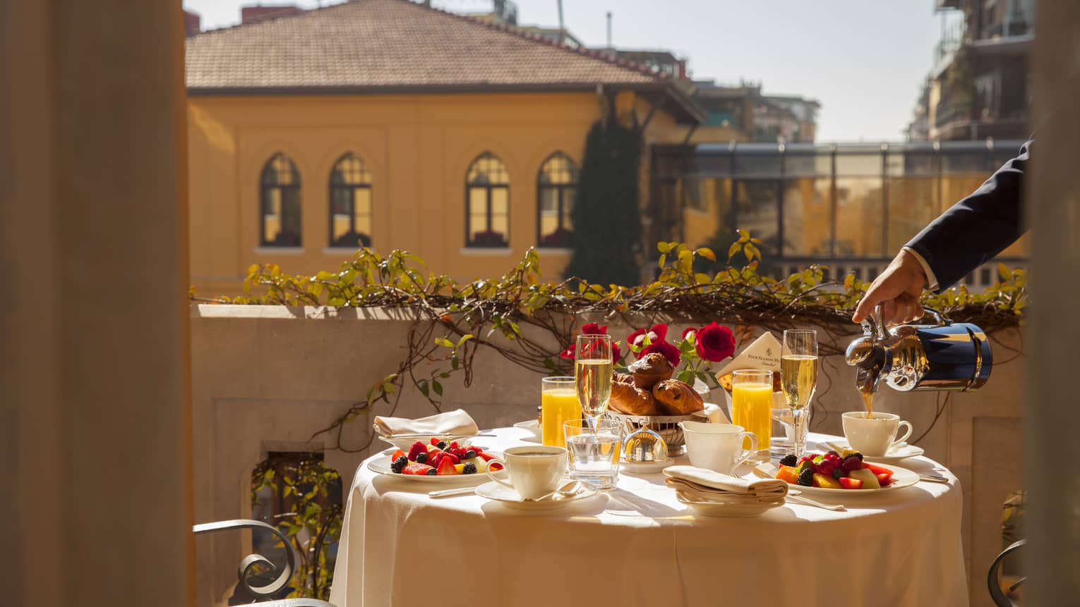 Breakfast set on terrace table with side of hotel view
