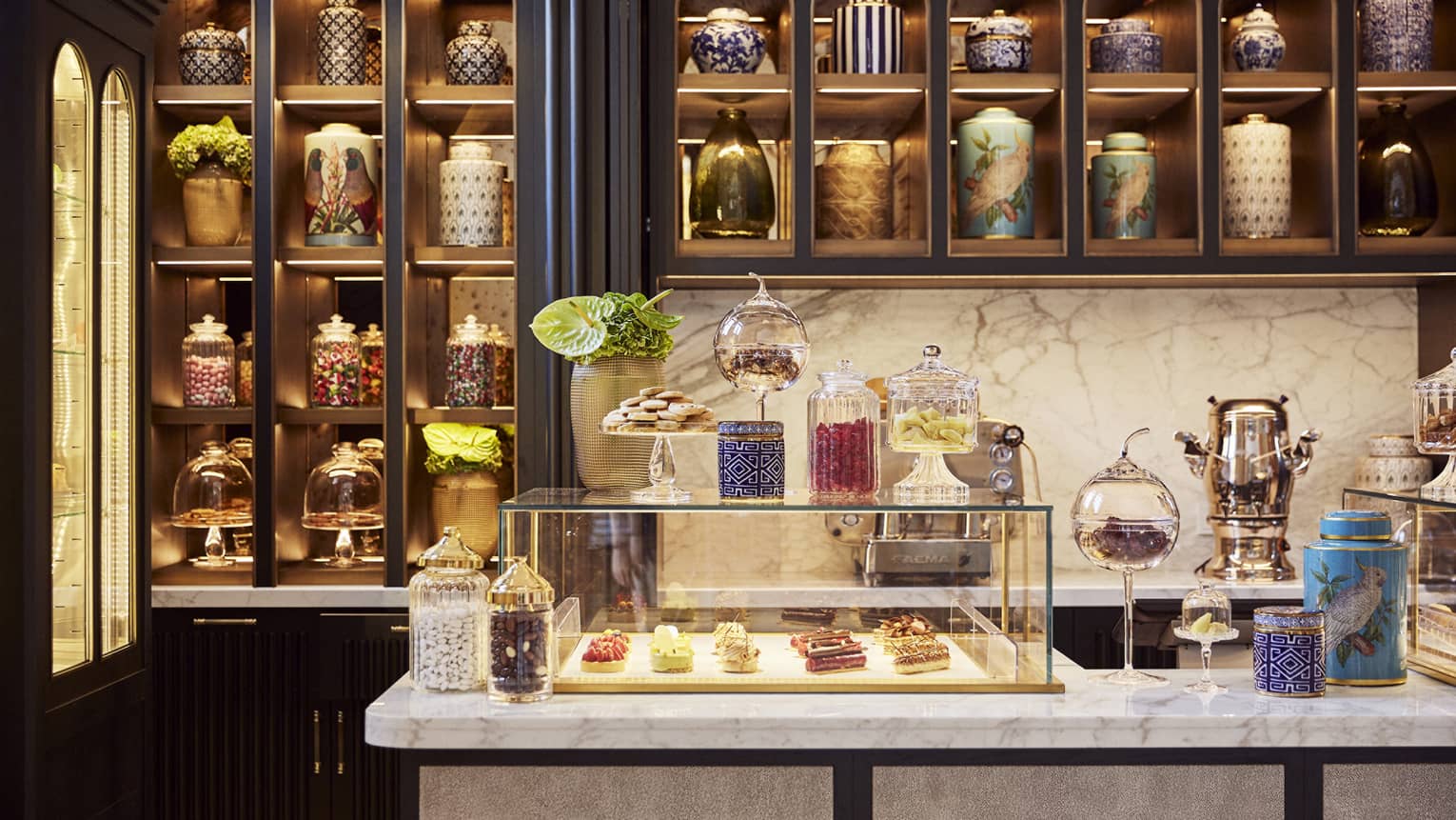 A pastry shop with pastries in a glass case.
