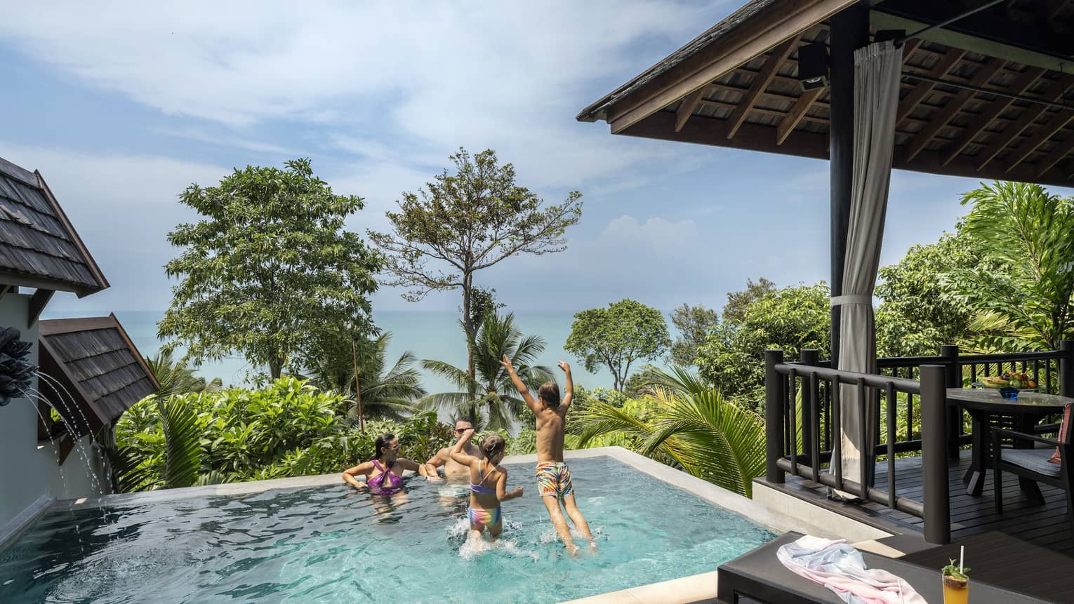 Family of four play in small pool of private pool