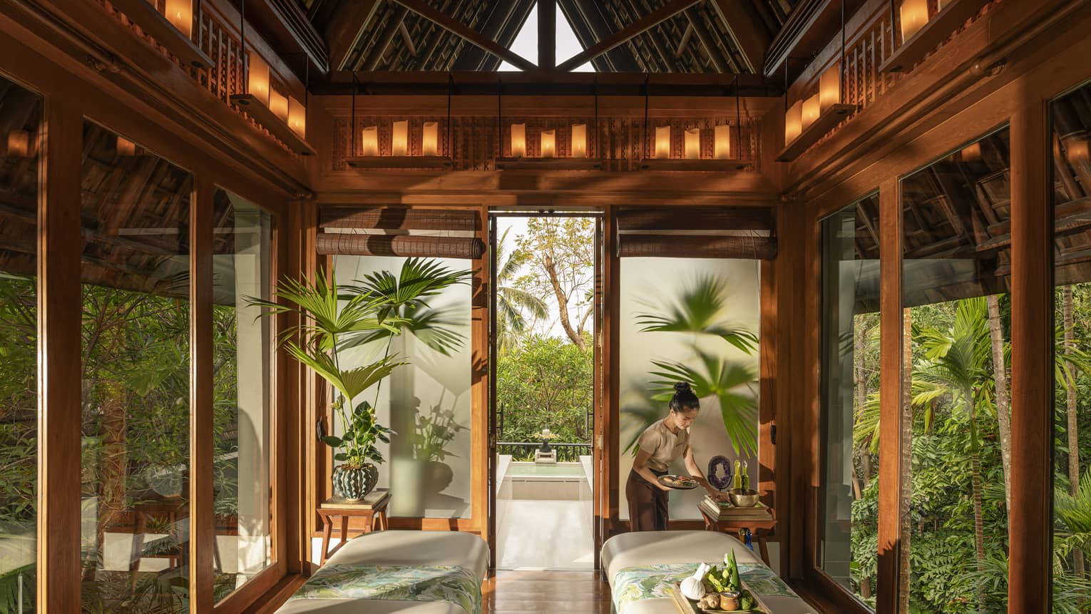 Spa team member prepares couples treatment room