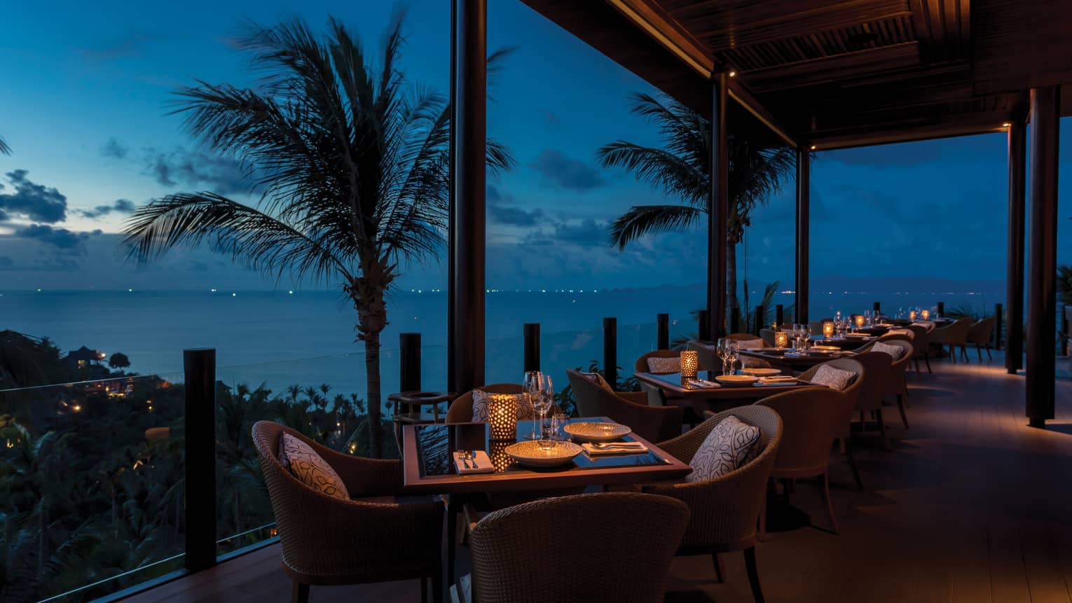 Outdoor terrace at Koh Thai Kitchen in Koh Samui, view of palm trees and Gulf of Thailand