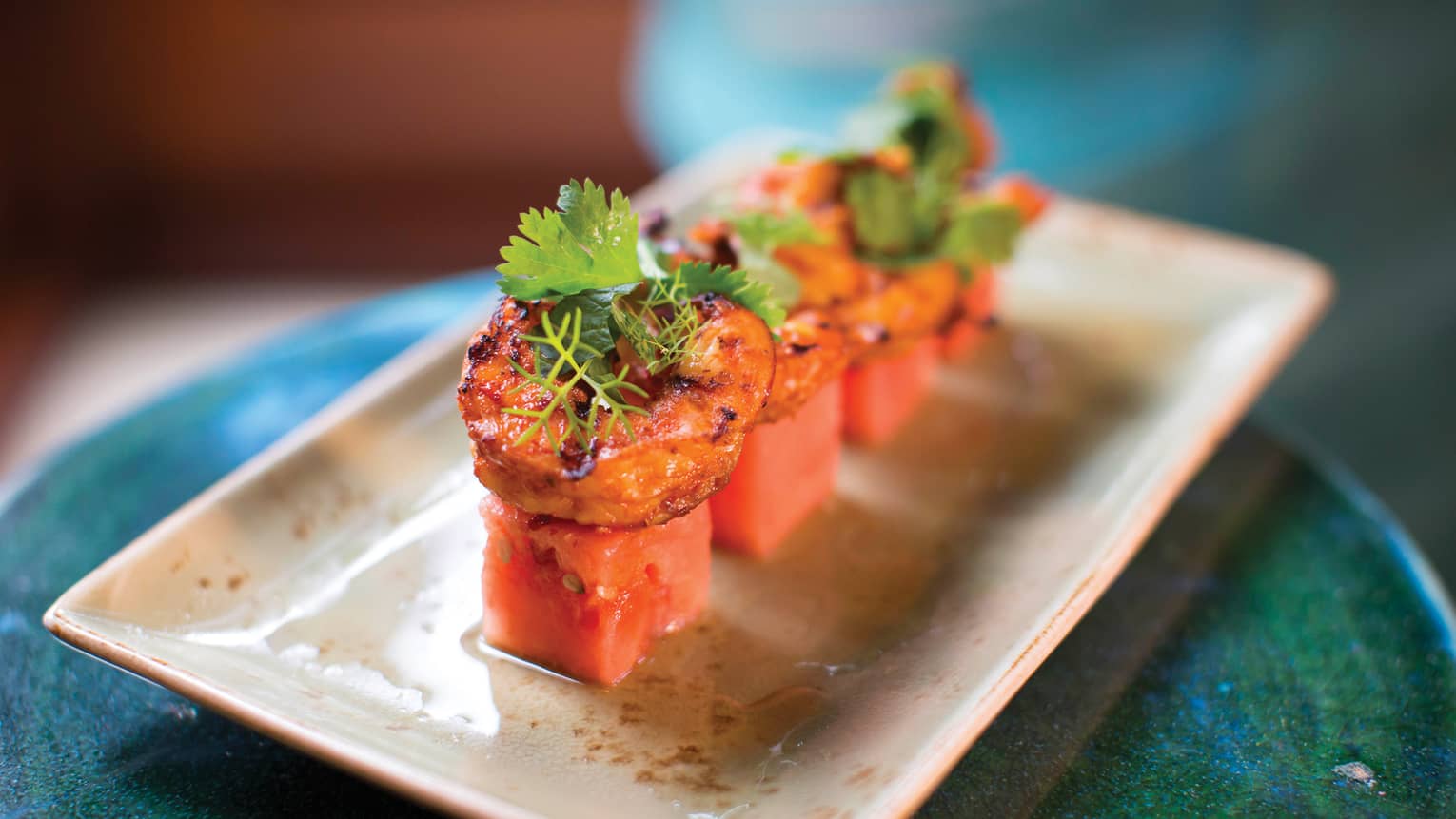 Watermelon cubes, shrimp arranged on platter