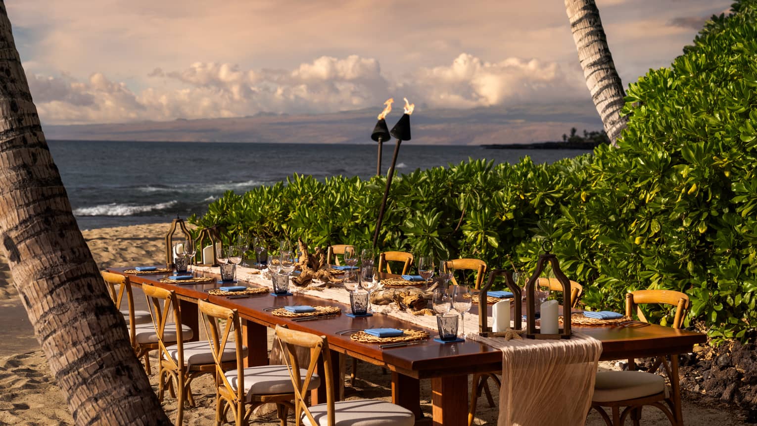 Private dining table seating 10 on the beach in tropical settig