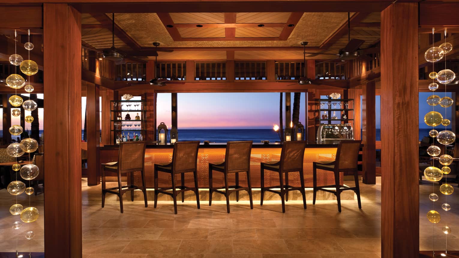 Stools along bar in ULU Sushi Lounge dining room, sunset views 