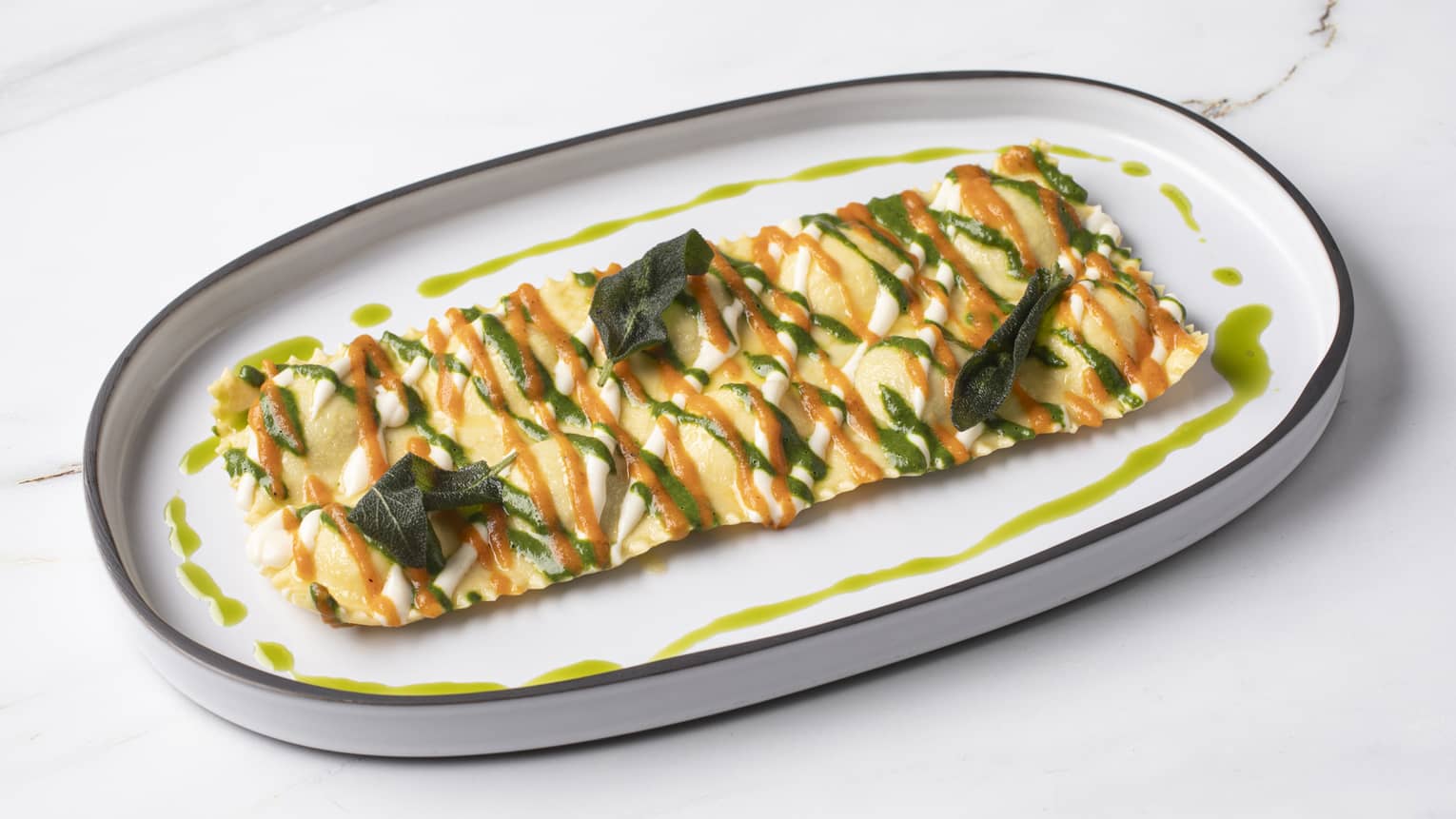 Giant raviolo with ricotta and spinach, served on a white plate with a blue rim.