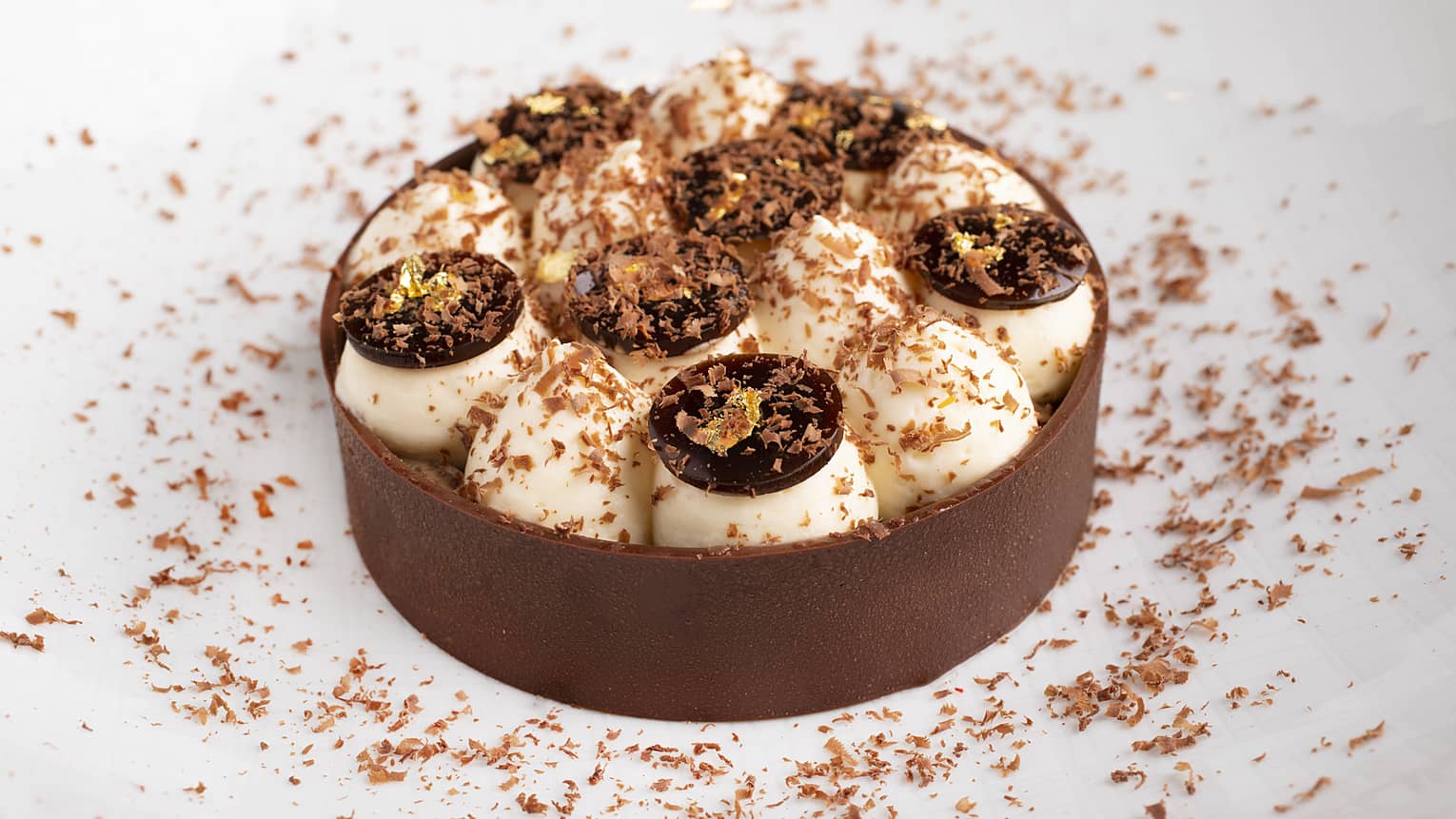 A tiramisu stuffed with cream and chocolate, then coated in chocolate scrapings.