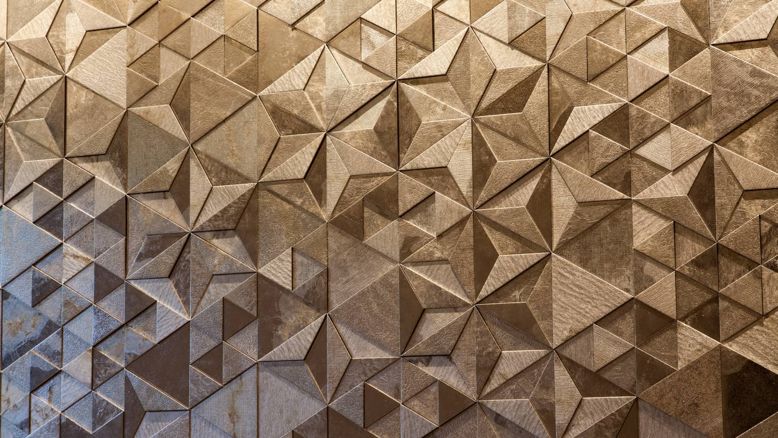 Close-up of Sushi Wakon geometric designs on silver tile wall