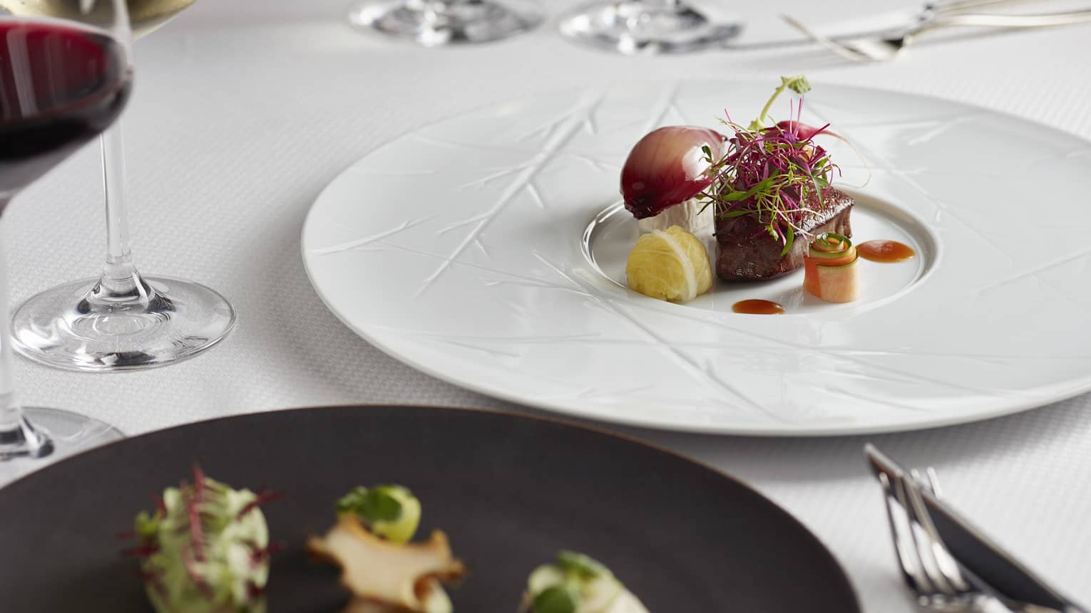 Private dining table, gourmet steak and vegetables on white plate