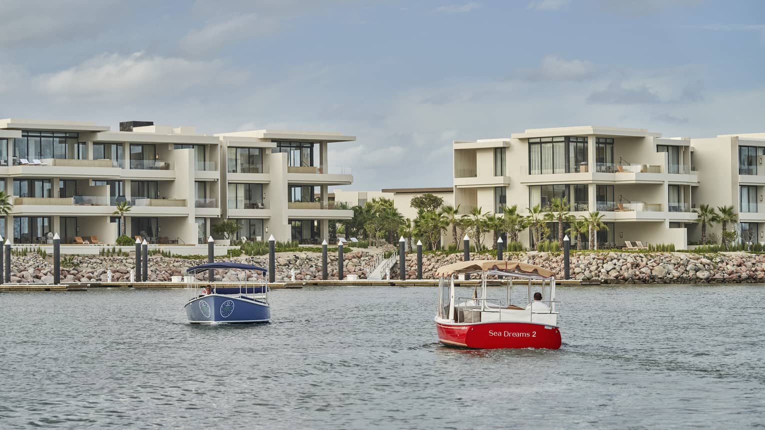 Two water taxis moving across water.