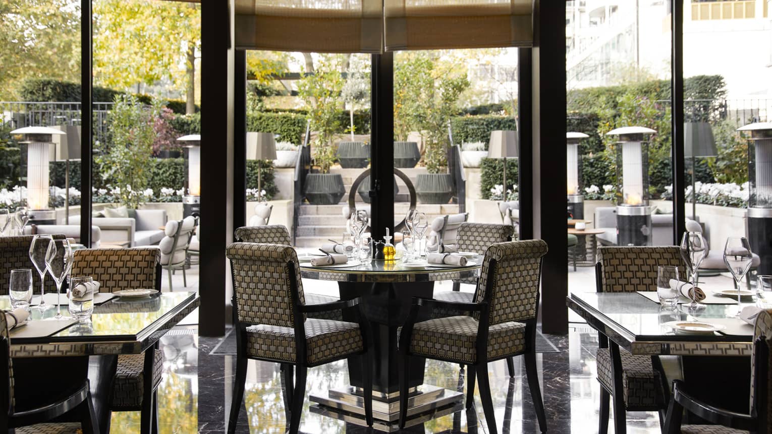 Dining area with floor-to-ceiling windows and outdoor terrace views