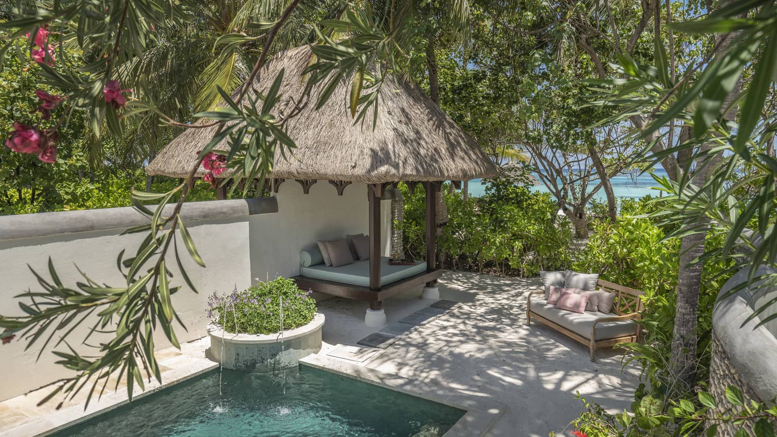 Private pool with thatched-roof cabana
