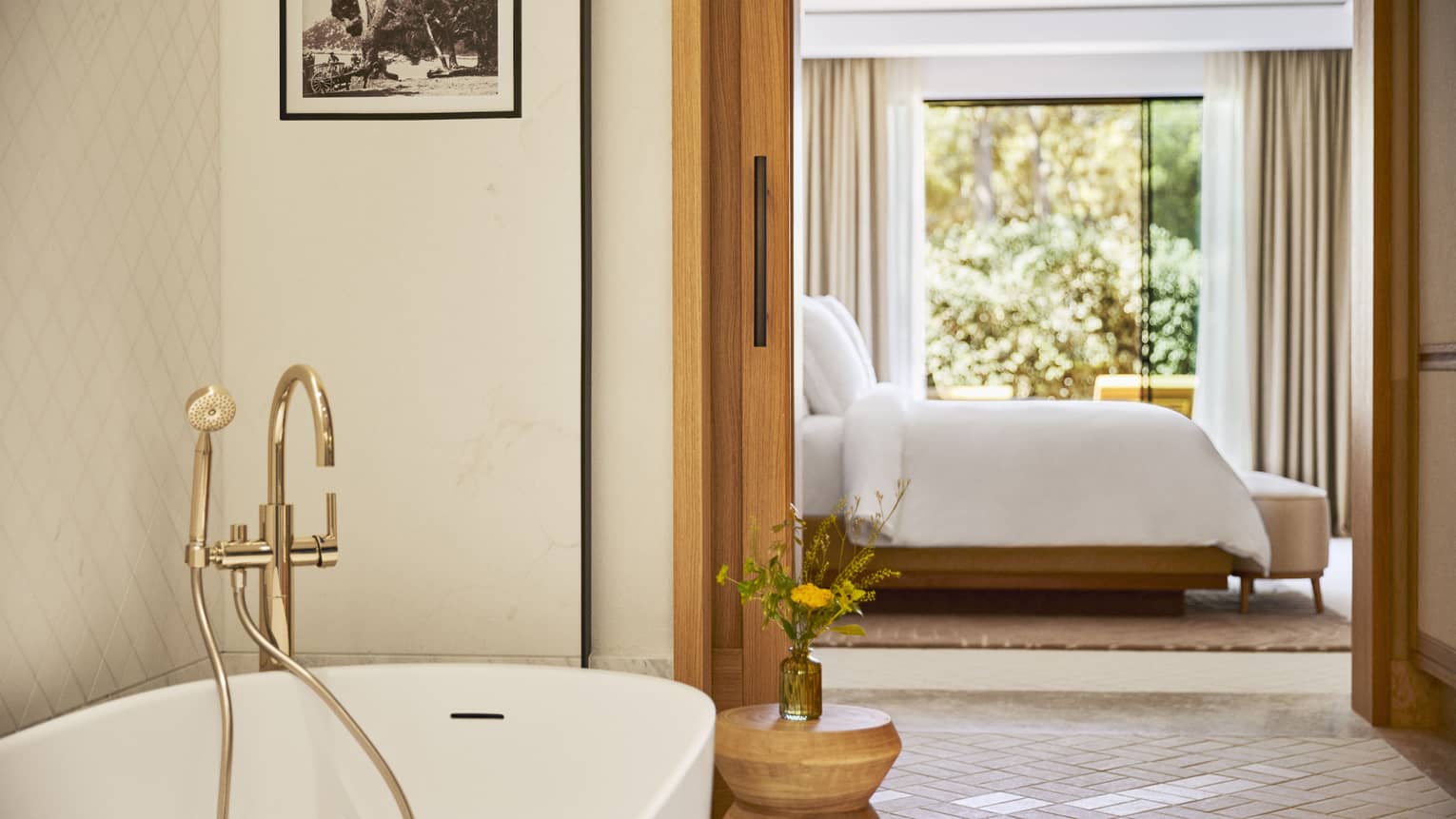 Luxury suite with standalone tub and king bed at Four Seasons Resort Mallorca