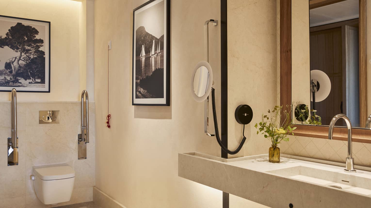 Accessible luxury hotel bathroom with grab bars by toilet