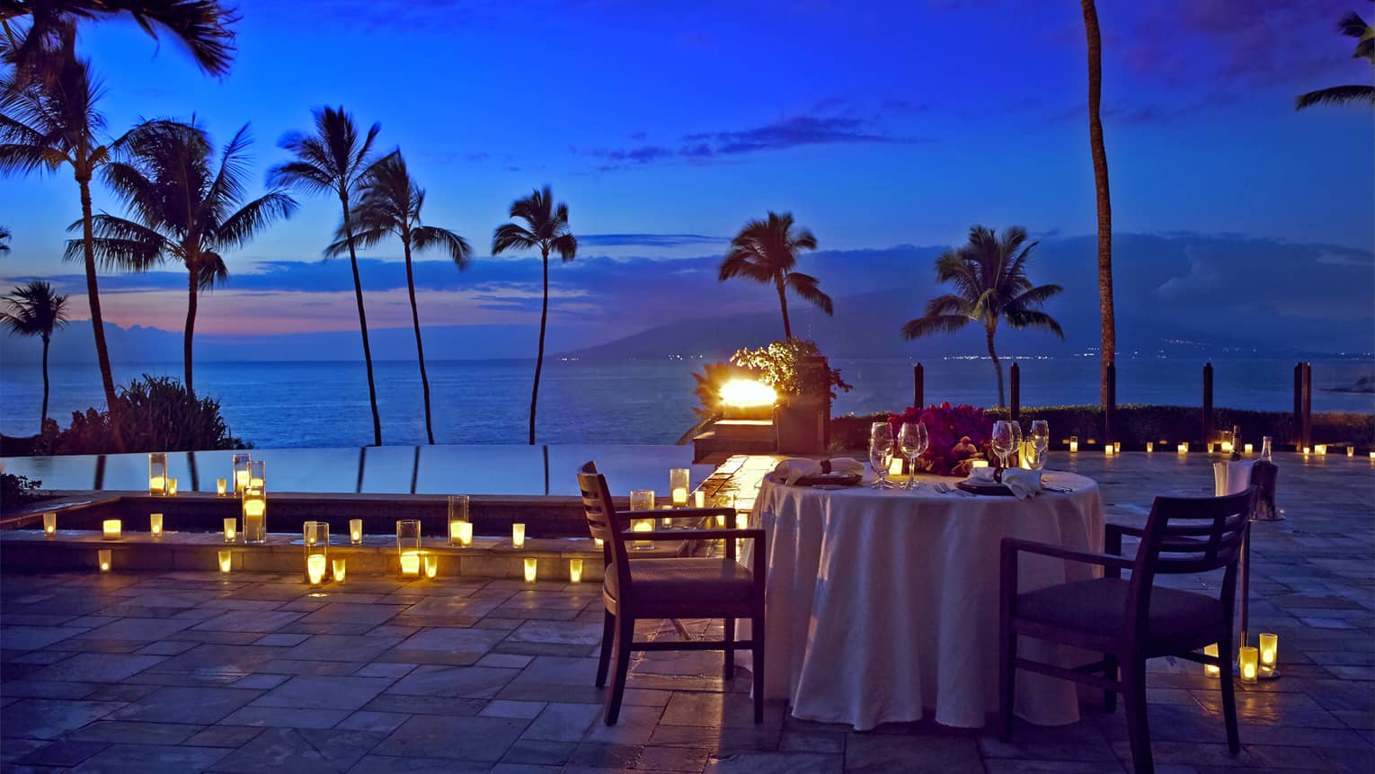 An outdoor candlelit dinner by the seaside in Maui