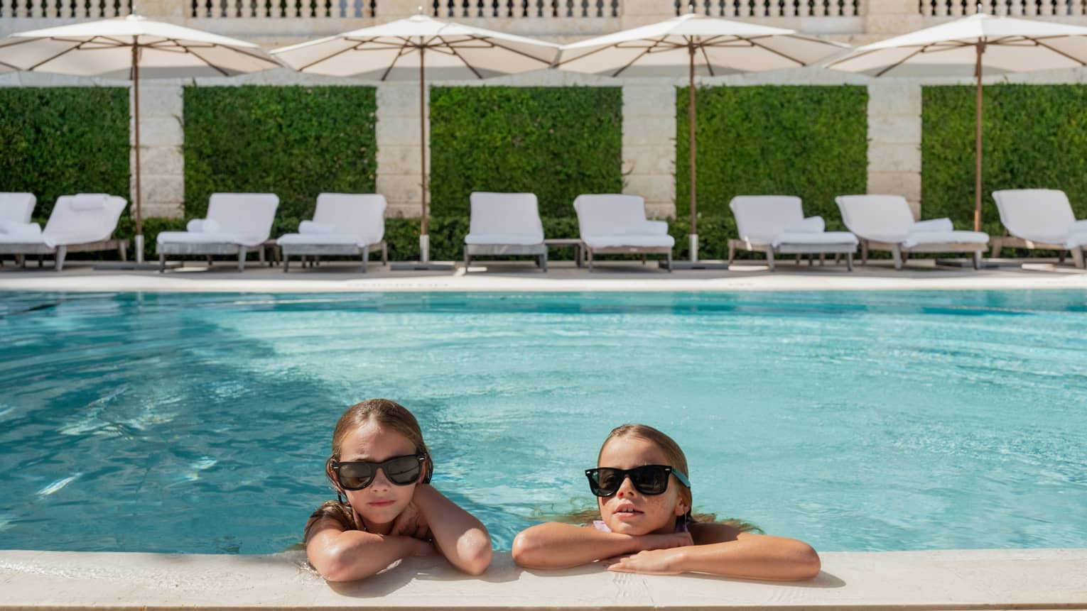Two young girls in luxury hotel pool