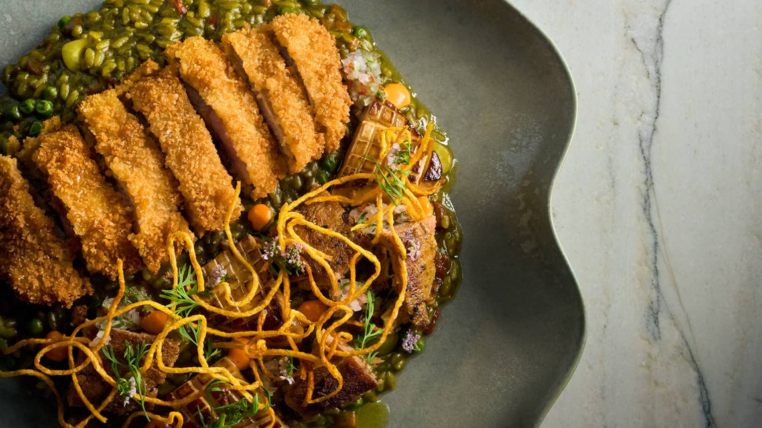 A culinary dish with duck, rice and vegetables