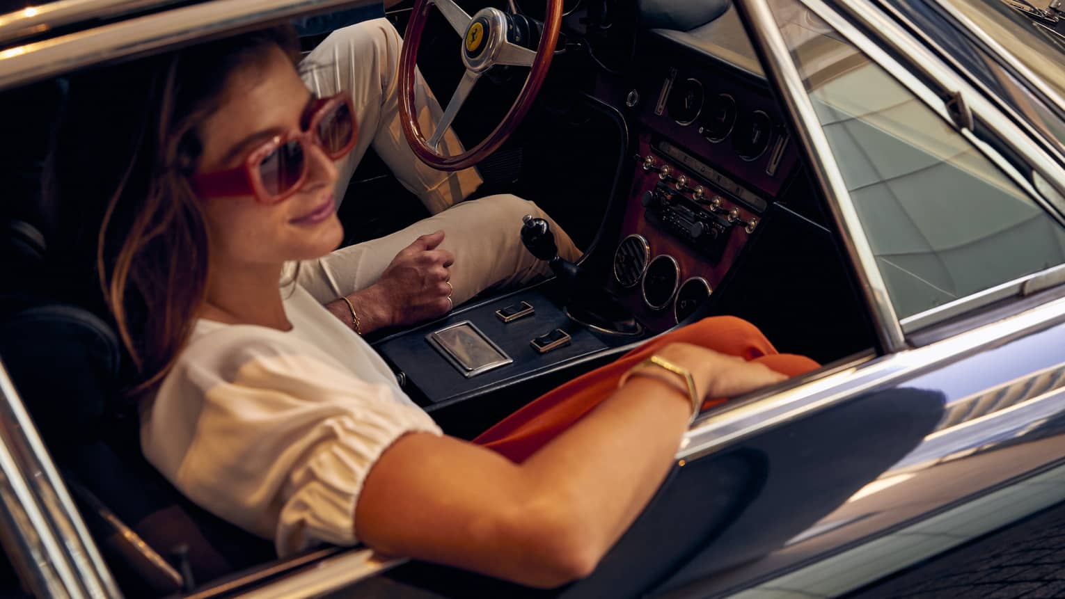 Woman looks out window of car