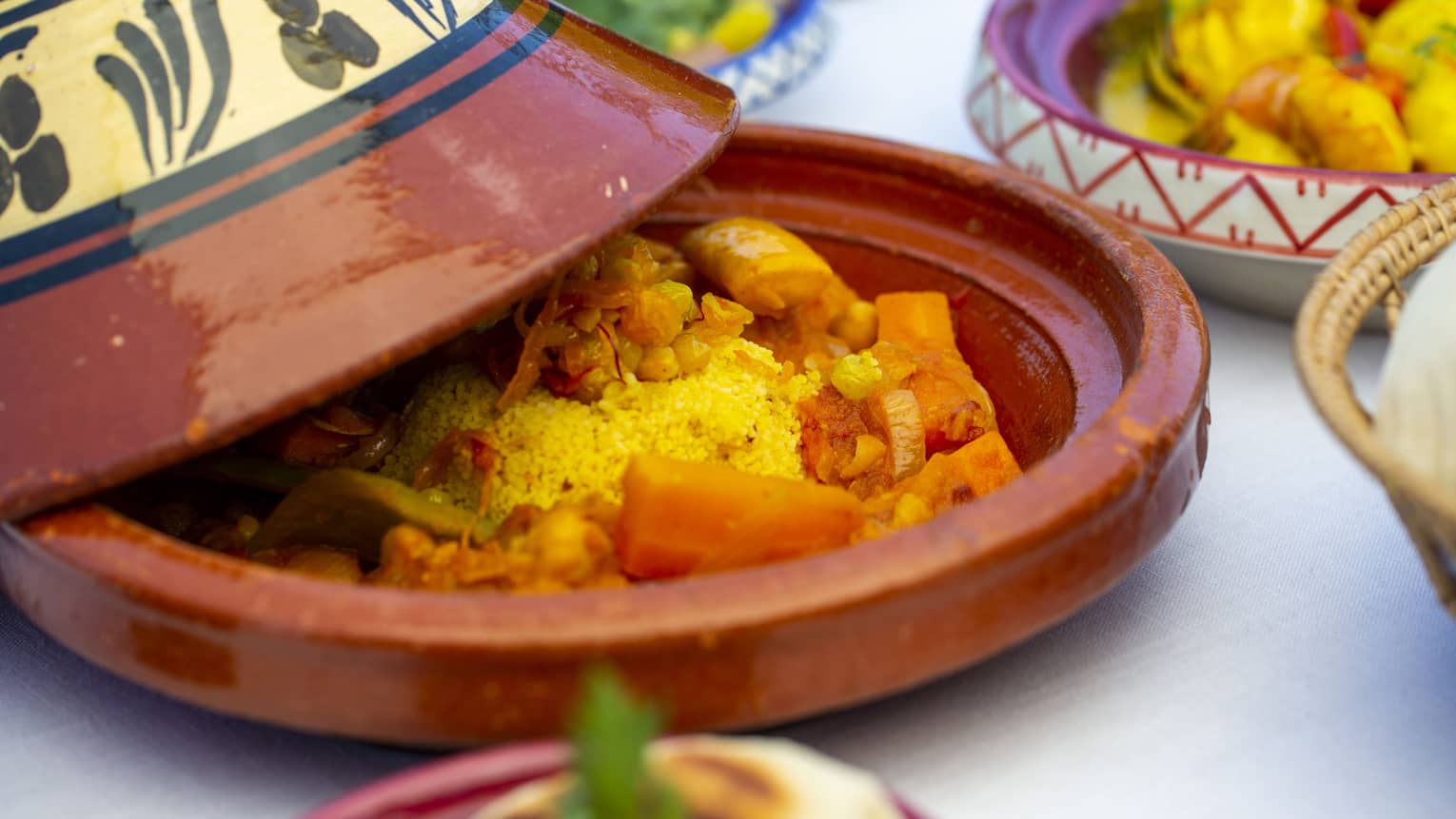 A close up of a vegetable dish in a terracotta plate with cover at Al Barakat