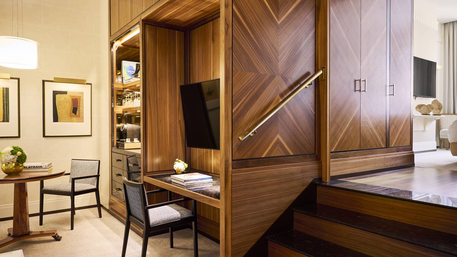 Luxury hotel room with wooden built-in desk/shelving system and TV