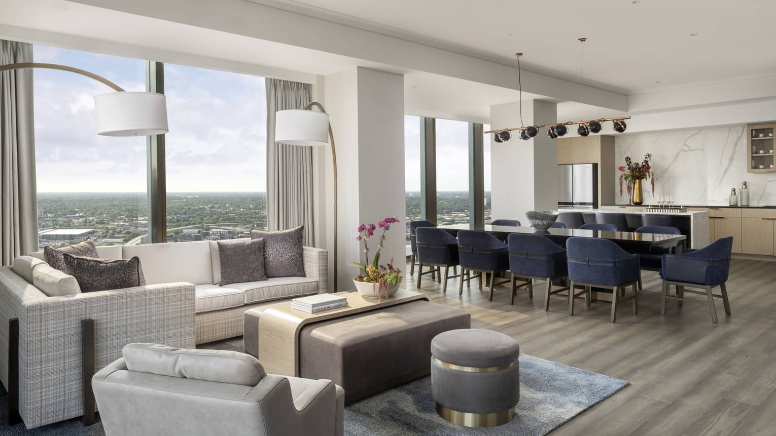 Hotel suite living room, dining room and kitchen with wall of windows
