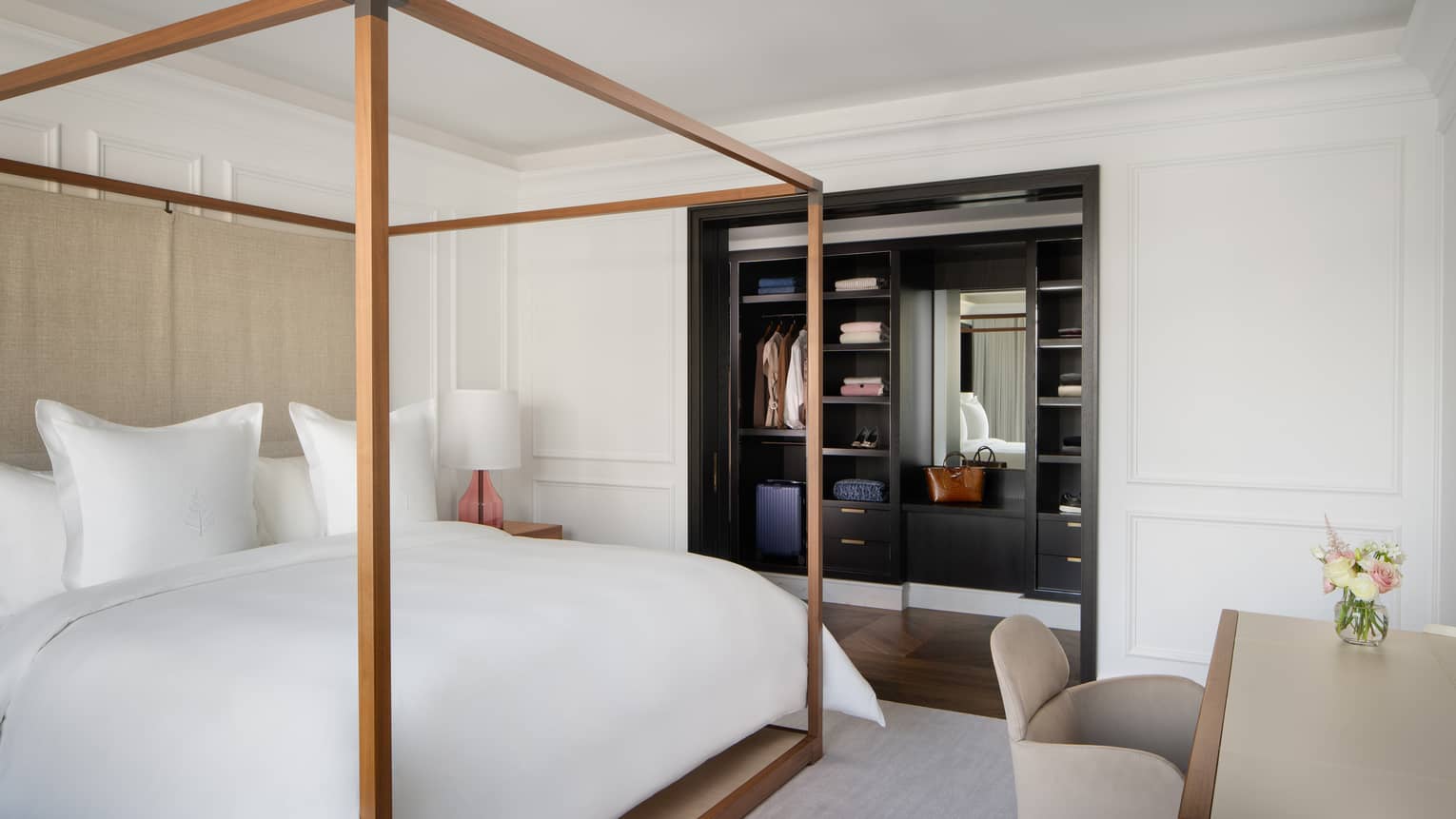 Bedroom with four-poster king bed, built-in closet and desk
