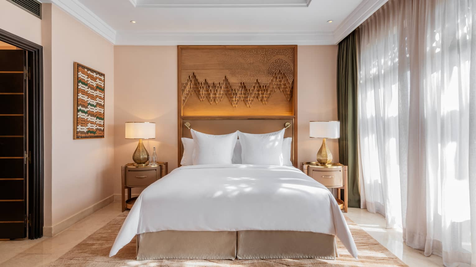 Marrakech hotel room with back-lit headboard and sheer window curtains