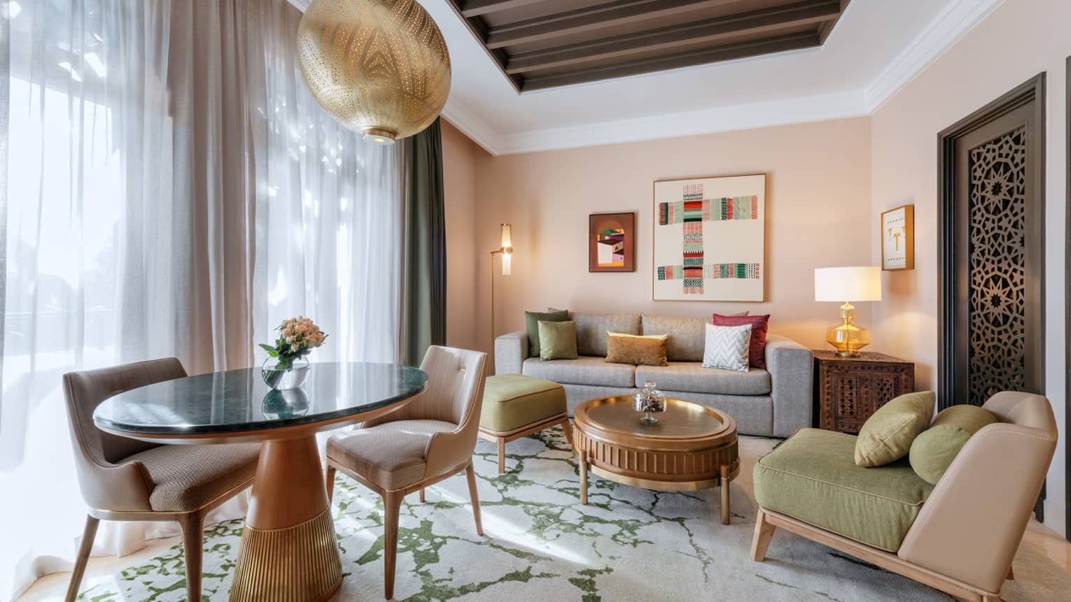 Marrakech hotel suite with sofa, arm chair and dining table with two chairs