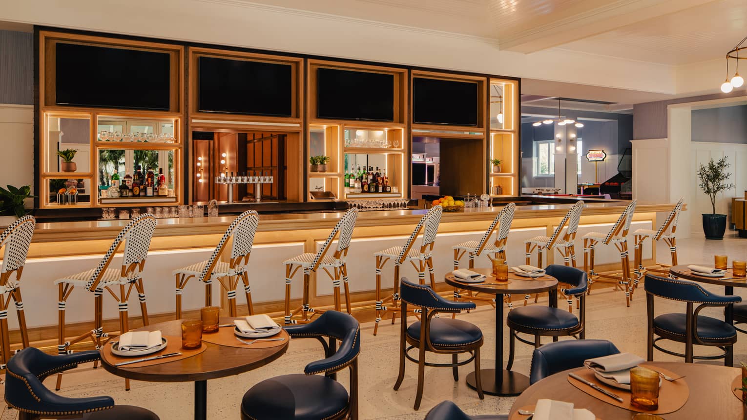 Restaurant dining room with bar counter and cocktail tables