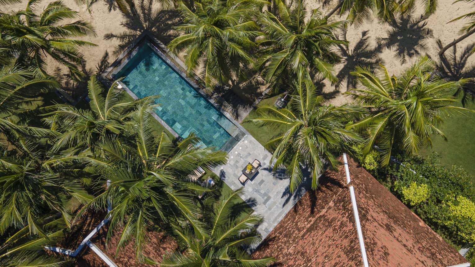 One Bedroom Pool Villa aerial view framed by palm trees