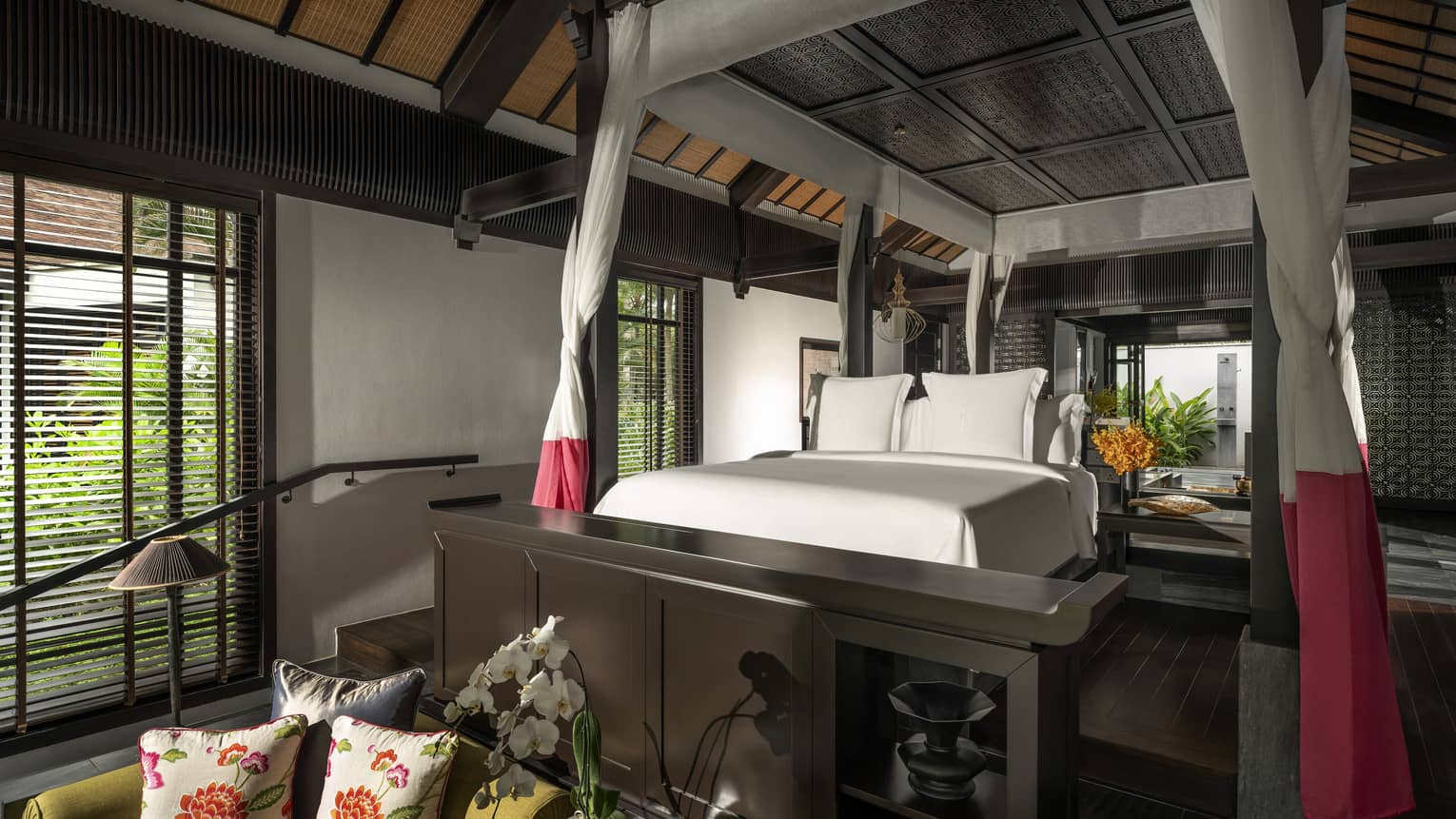 Luxury resort room with netting around the king bed and sitting area