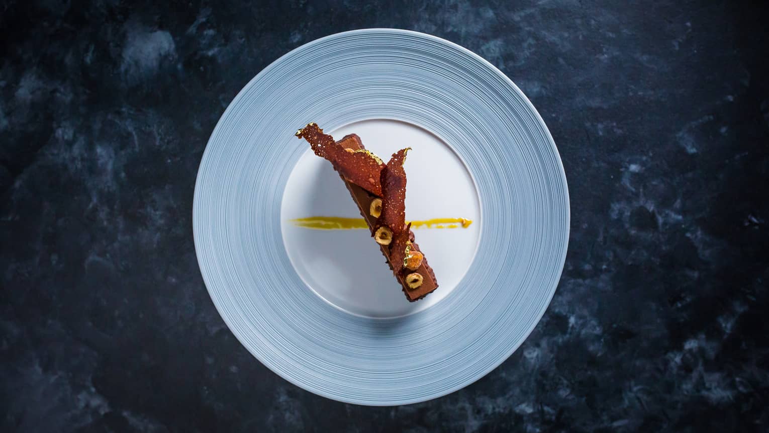 A chocolate dessert on a blue plate.