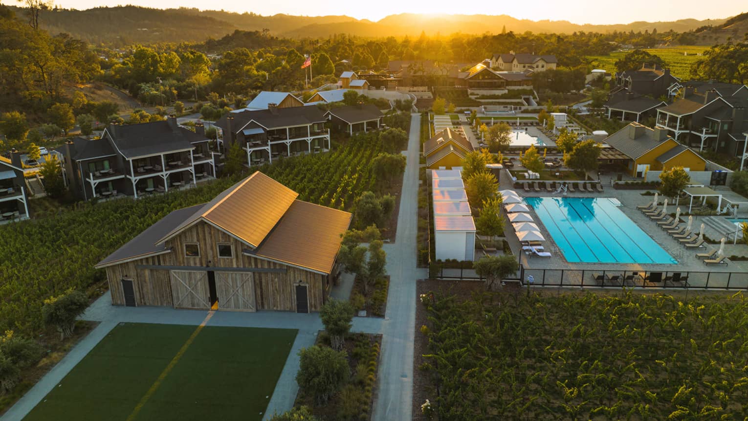 Aerial view of Four Seasons Resort Napa Valley grounds, including pool and vineyards