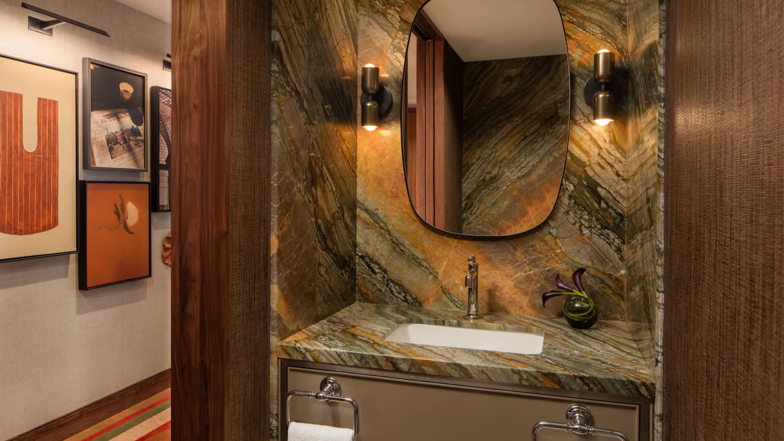 Stylish powder room with granite vanity and matching backsplash spanning the entire wall