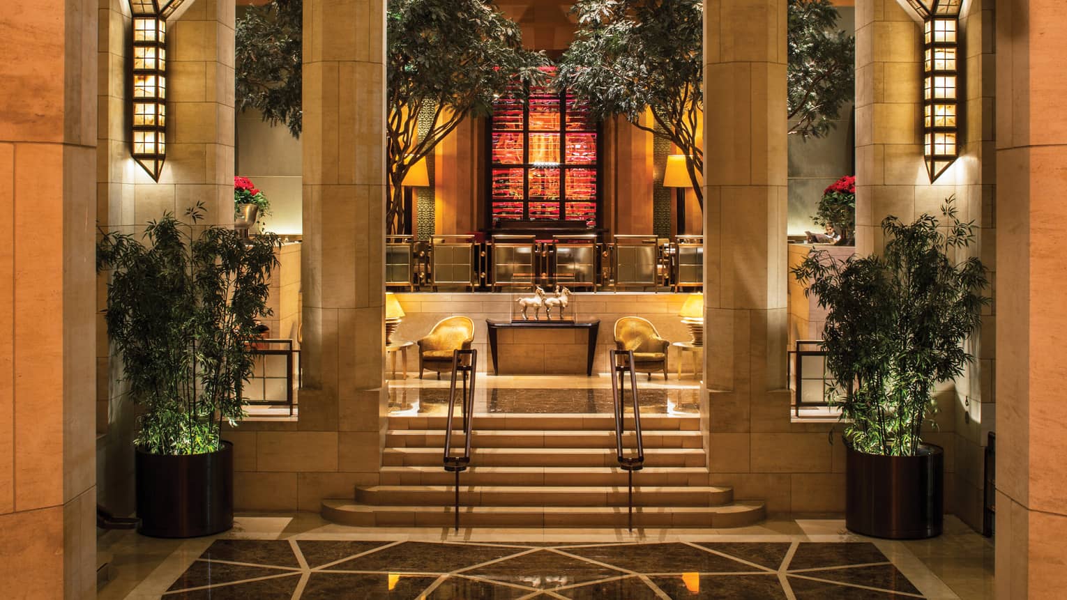 Garden Restaurant marble steps leading up to planters, indoor trees, lounge chairs, horse statues