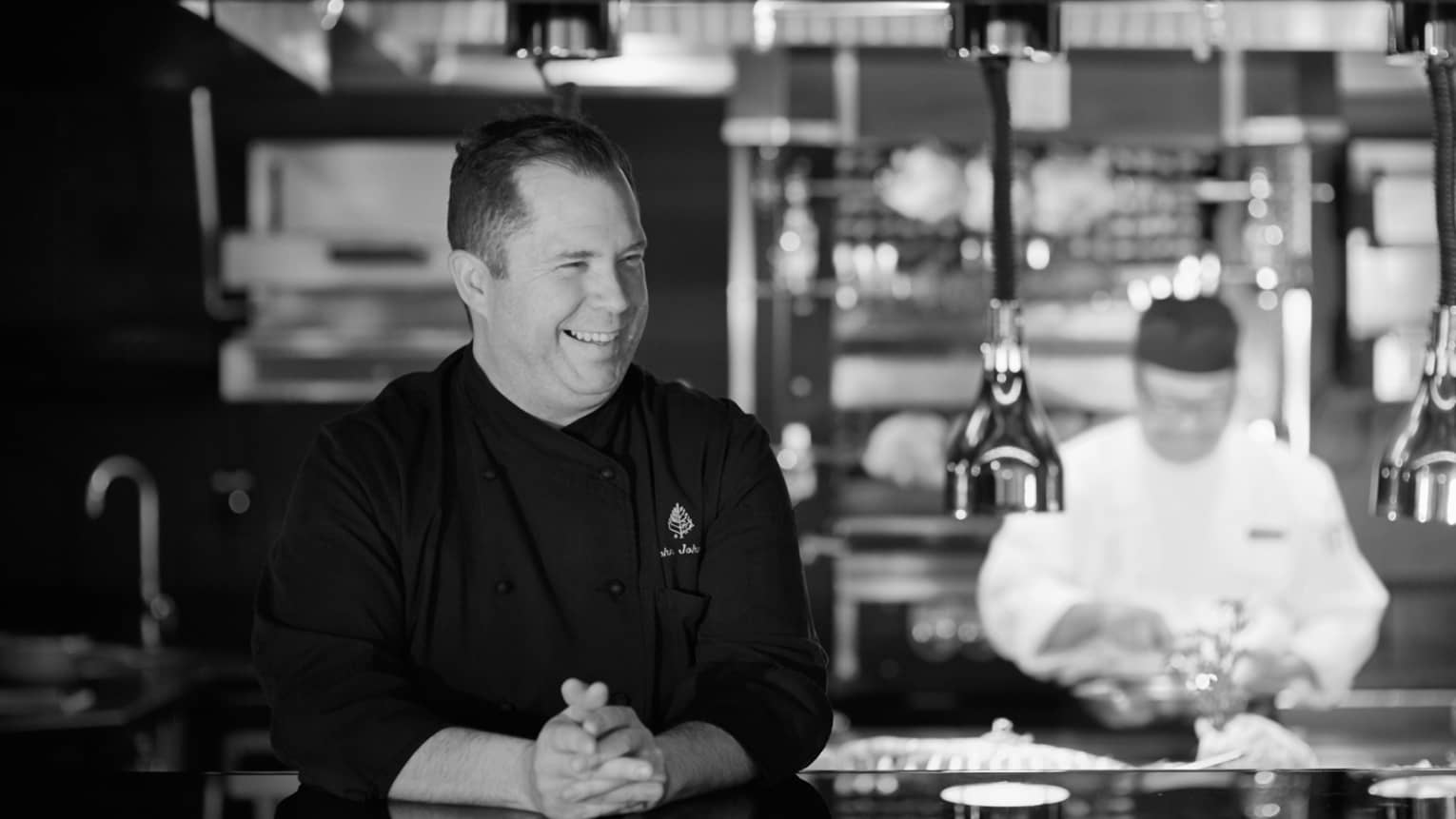 Black and white portrait photo of Executive Chef John Johnson in kitchen