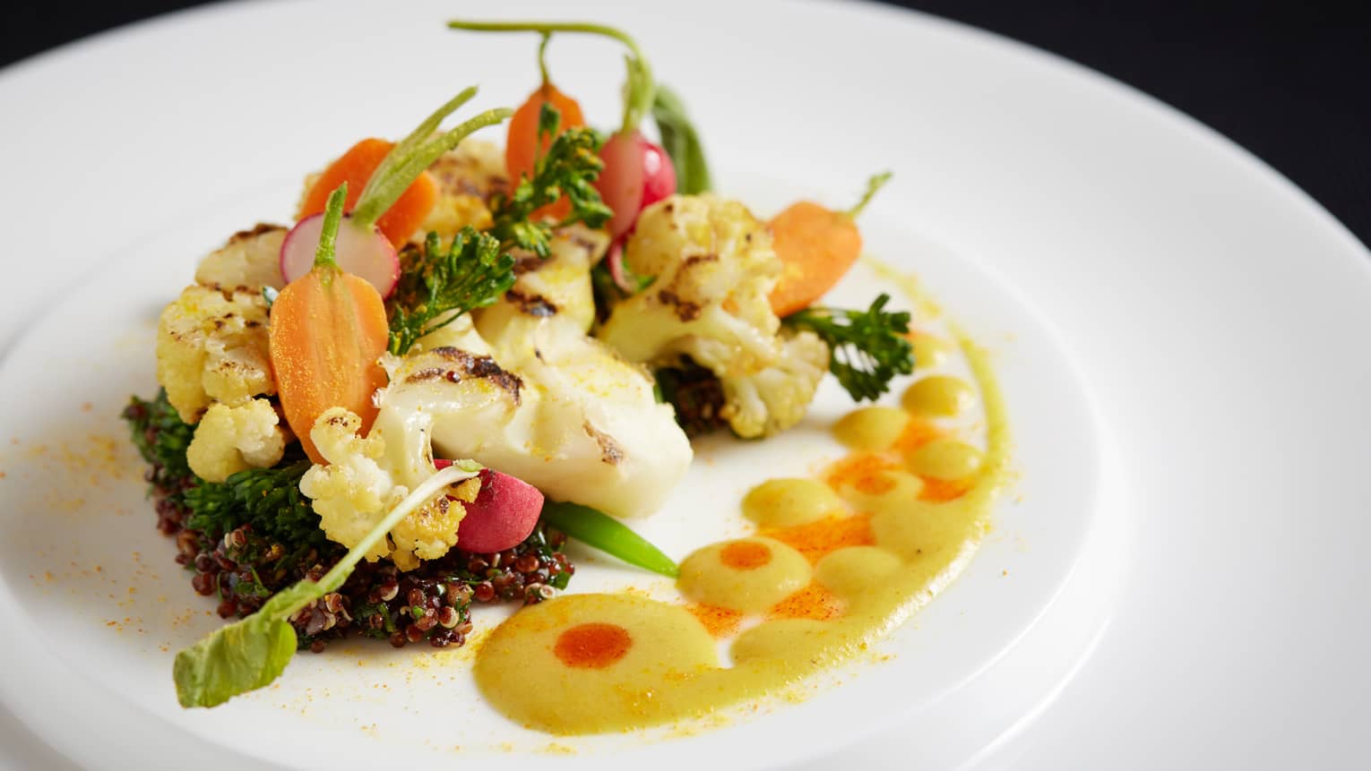 The Garden cauliflower steak with black walnut quinoa and fragrant pear curry emulsion, on plate