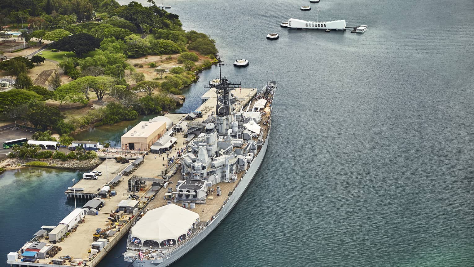 Aerial view of large battleship, people on dock at Battleship Missouri Memorial at Pearl Harbor