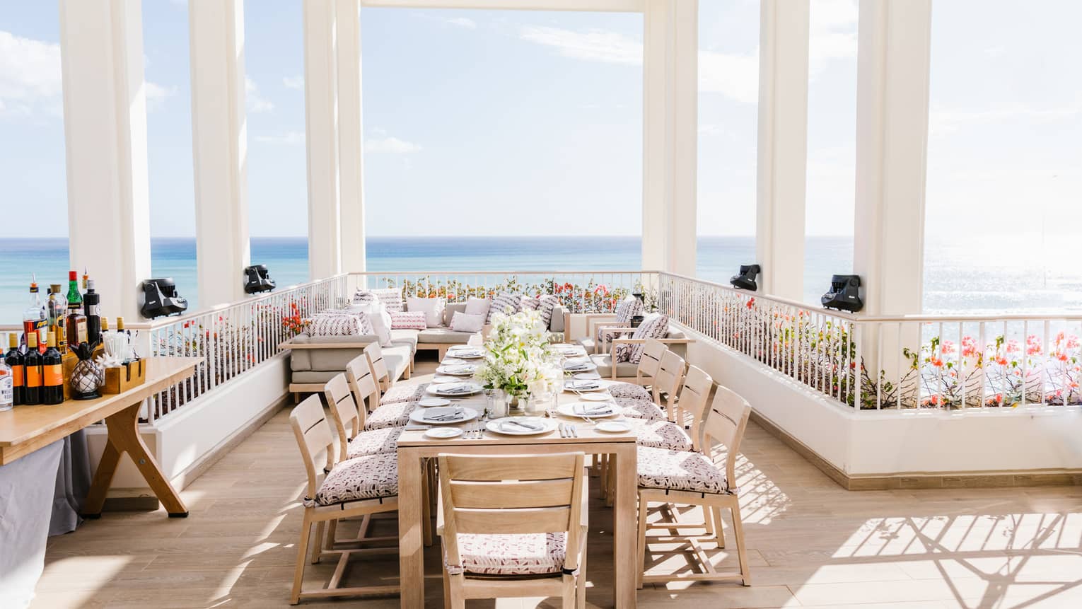 Set dining table on private terrace overlooking ocean