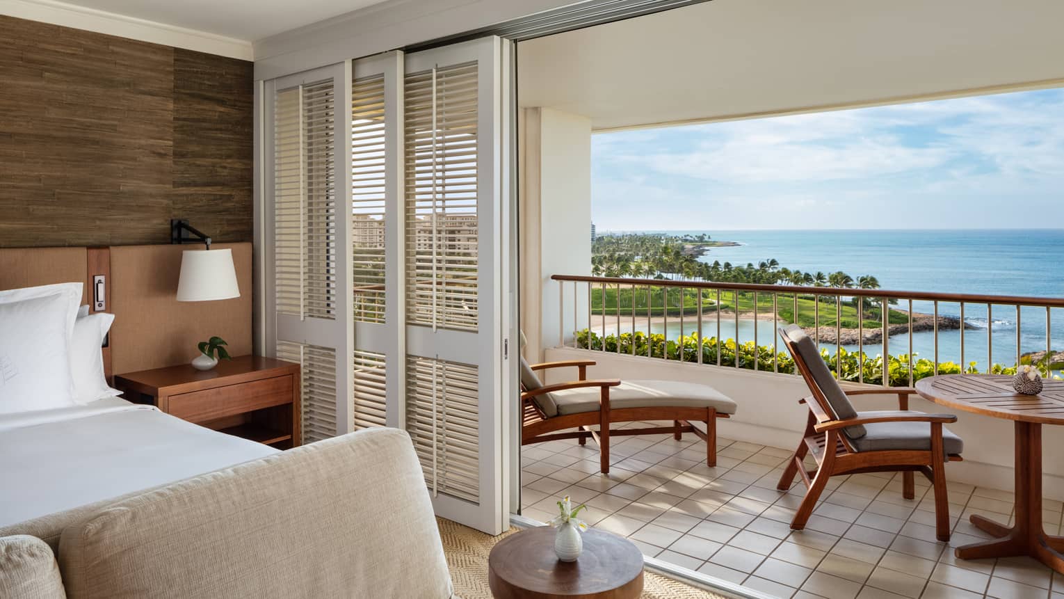 Hotel room with furnished ocean-view balcony