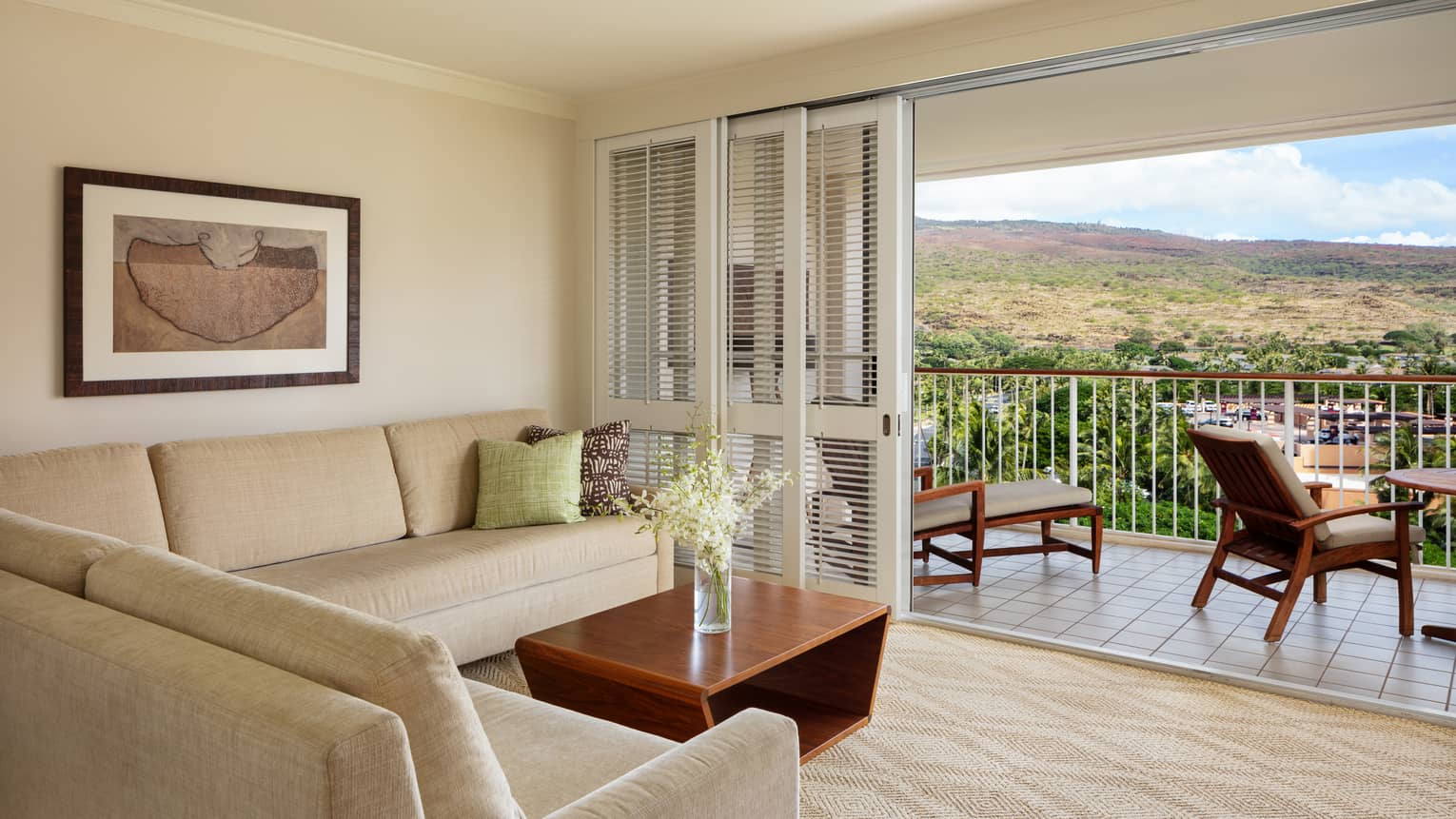 Guest suite with two cream sofas opening to a balcony