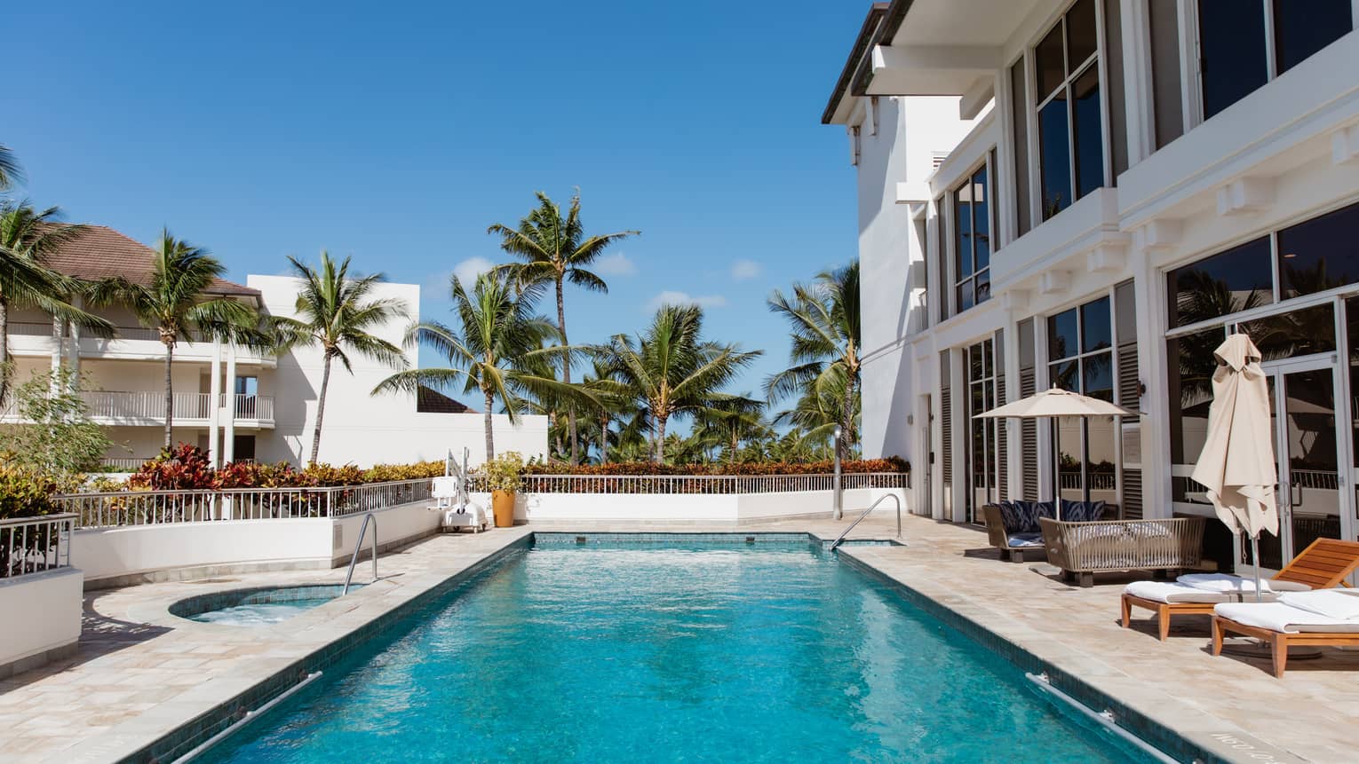 Outdoor resort pool with palm trees at Four Seasons Resort Oahu at Ko Olina