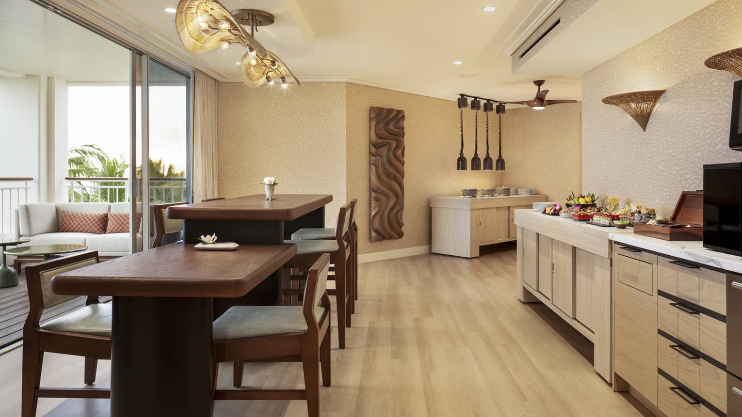 Self-serve counter and two dining tables of different heights in an executive club lounge at resort
