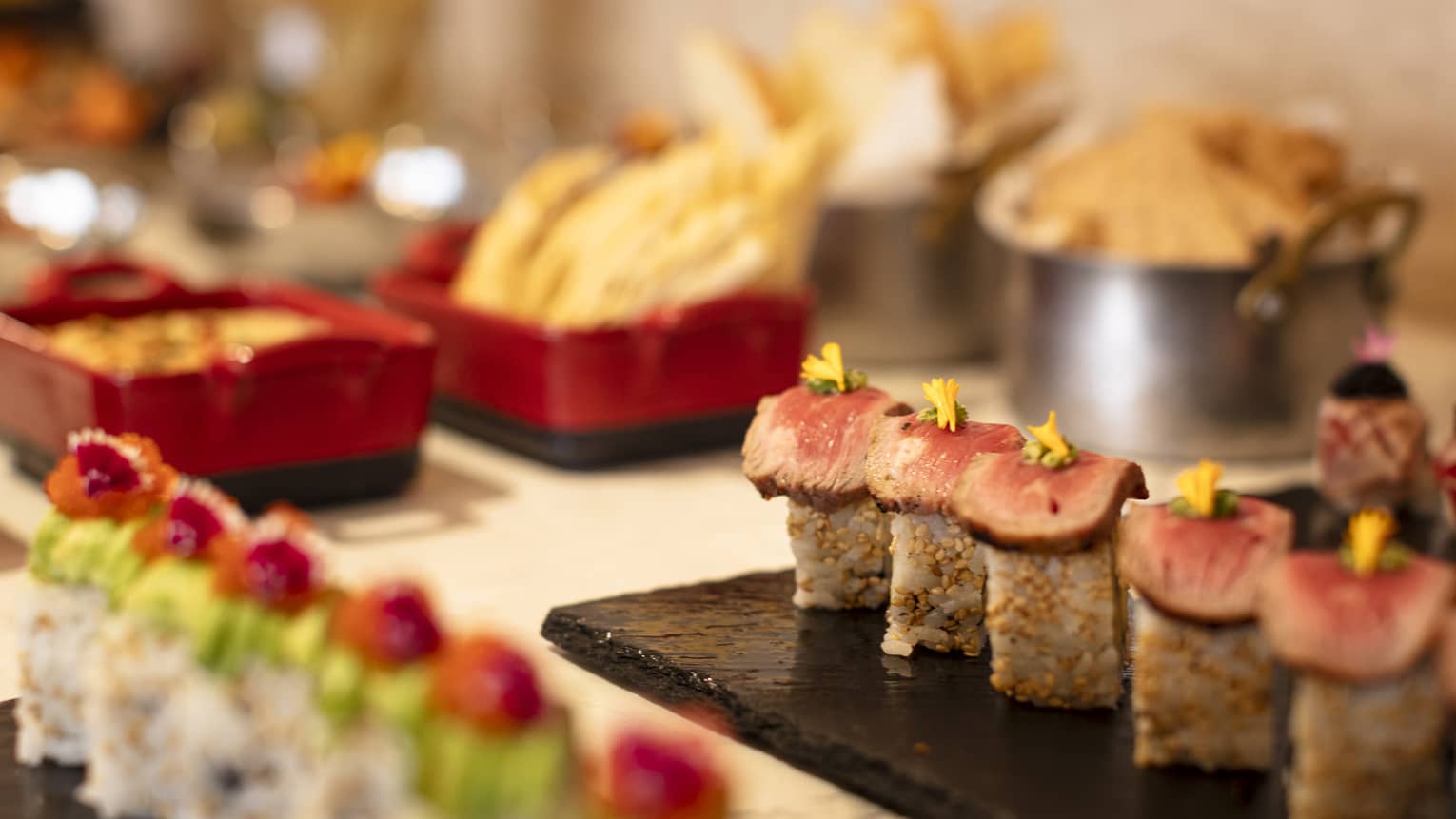 Platters of sushi on a buffet counter