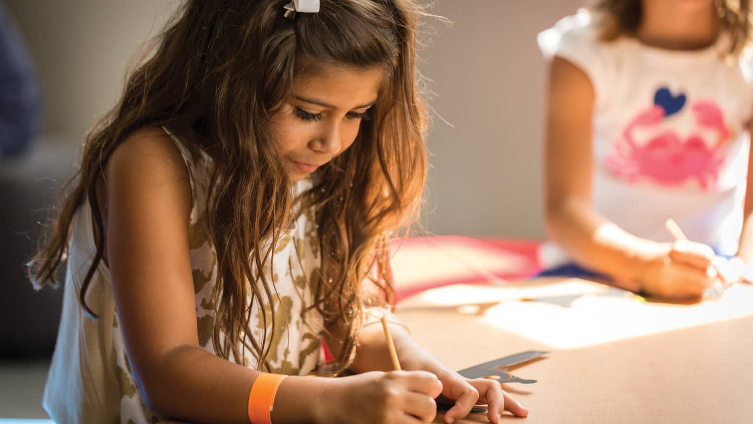 Young girl colours picture in Kids Centre