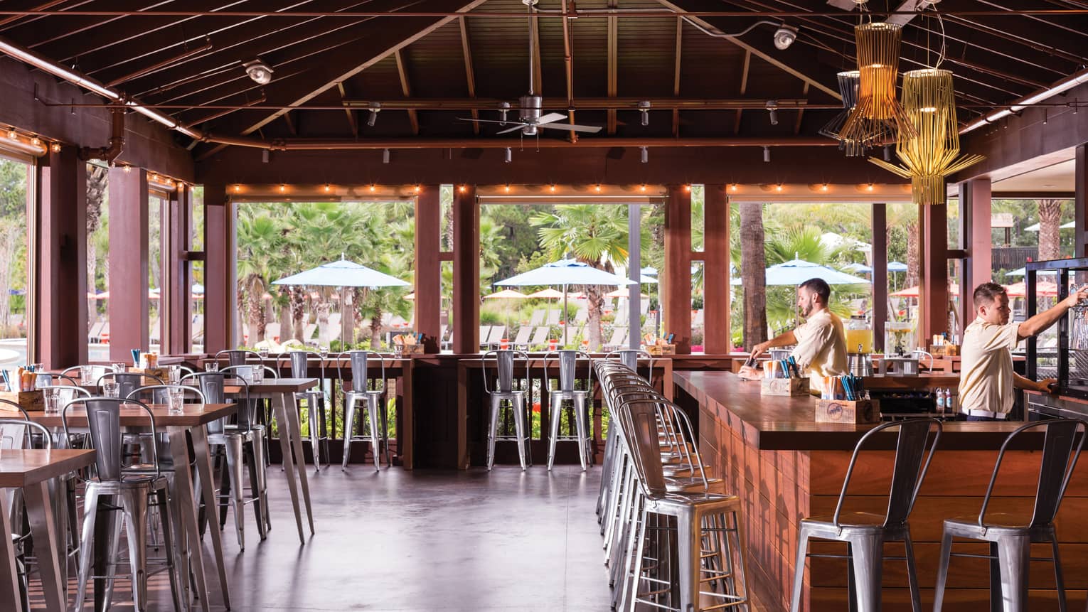 A light-filled and airy partially outdoor dining space with bar and table seating