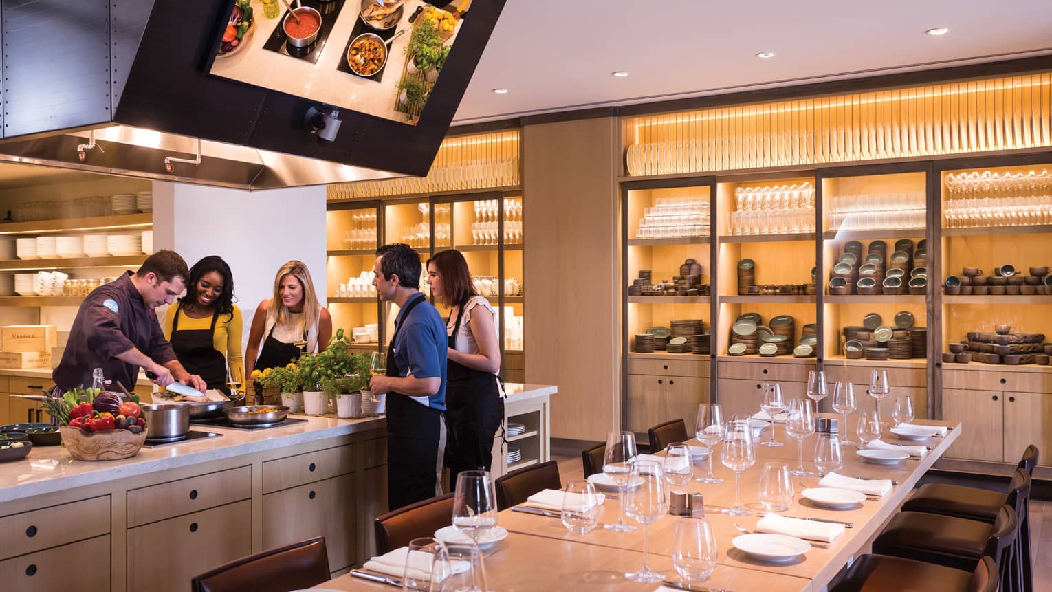 Ravello Kitchen private dining table, group gathered around counter, chef during cooking demonstration